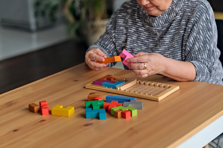 older person doing a puzzle for brain training