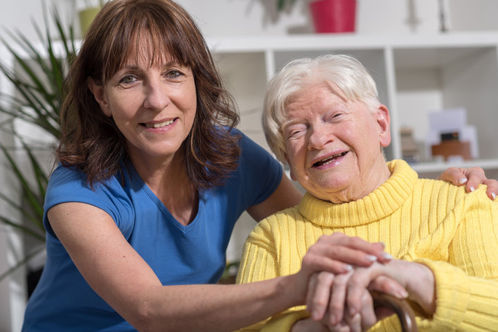 elderly mum and daughter smiling