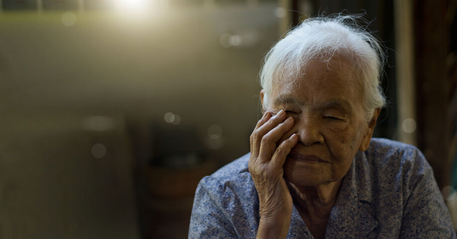 An elderly Asian woman with Alzheimer's and memory loss sitting alone in house, Memory loss due to dementia.