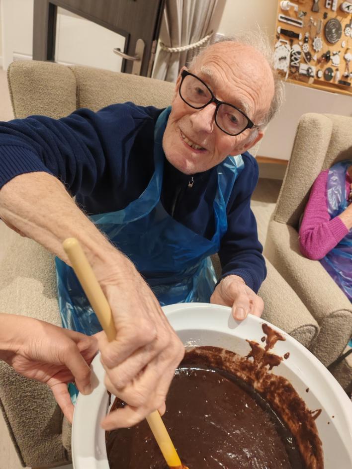 resident mixing brownie mix in a bowl