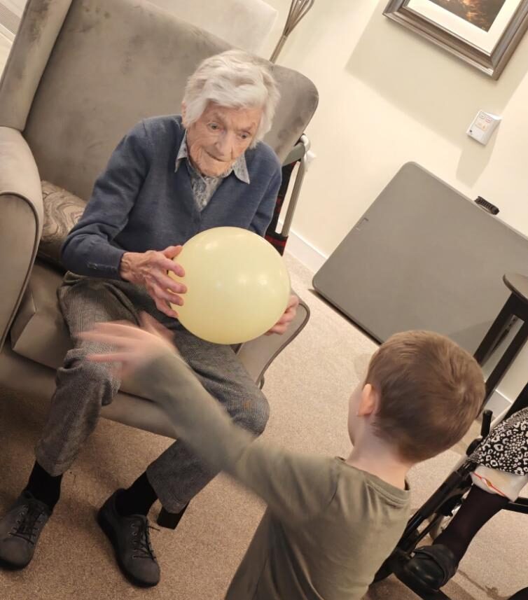 resident with a ballon with a child