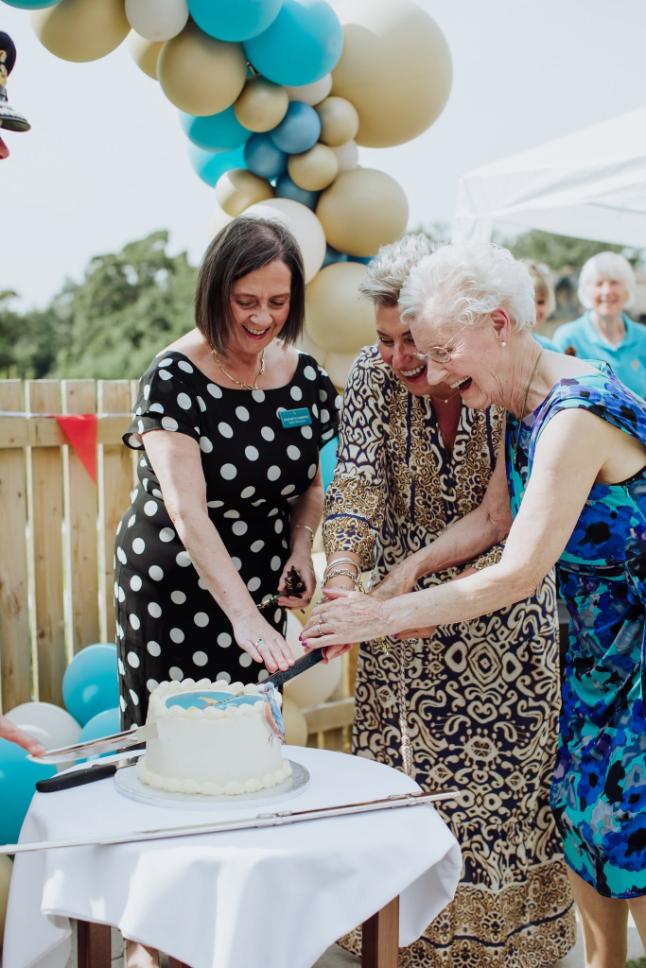 managers cutting cakes