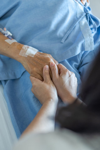 nurse holding resident hand