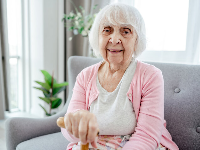 older woman with a stick in the care home