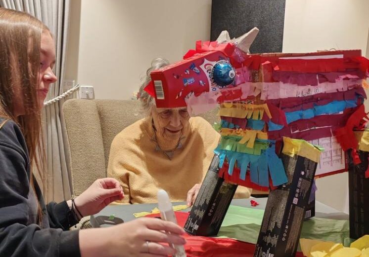 resident and carer making a piñata